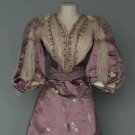 TRAINED PURPLE BROCADE EVENING GOWN, c. 1896