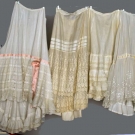 FOUR WHITE LAWN PETTICOATS, 1890-1910