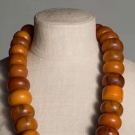 TWENTY EIGHT LARGE EGG YOLK AMBER BEADS